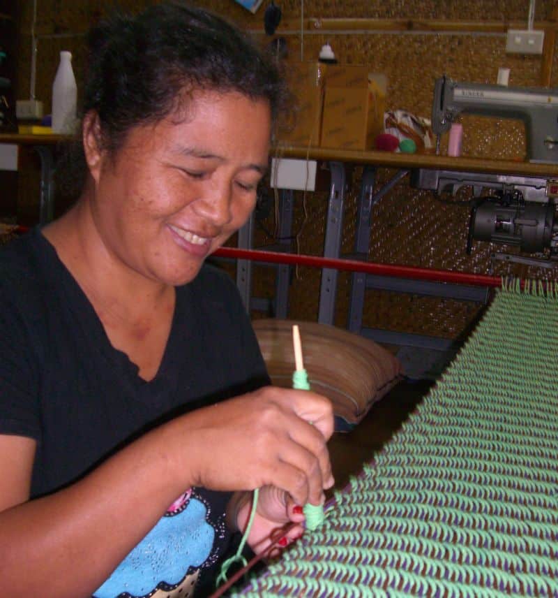 Thai hill tribe woman happily weaving hammock bed