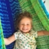 Smiling baby girl happy in a huge hammock