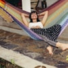Smiling woman relaxing in hammock outdoors in Sydney NSW